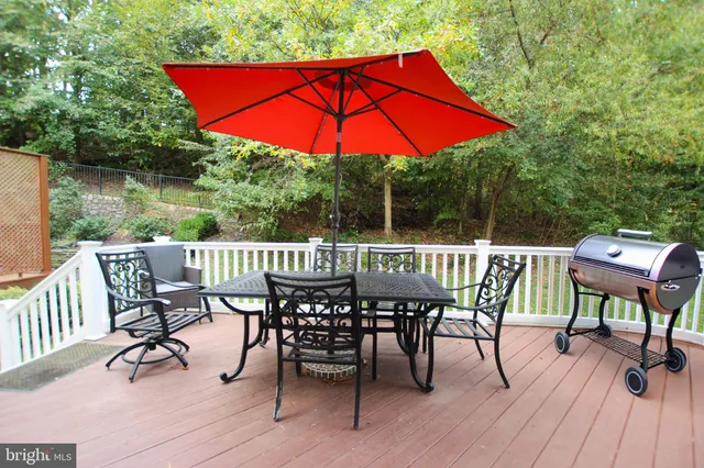 a view of a deck with furniture and a backyard