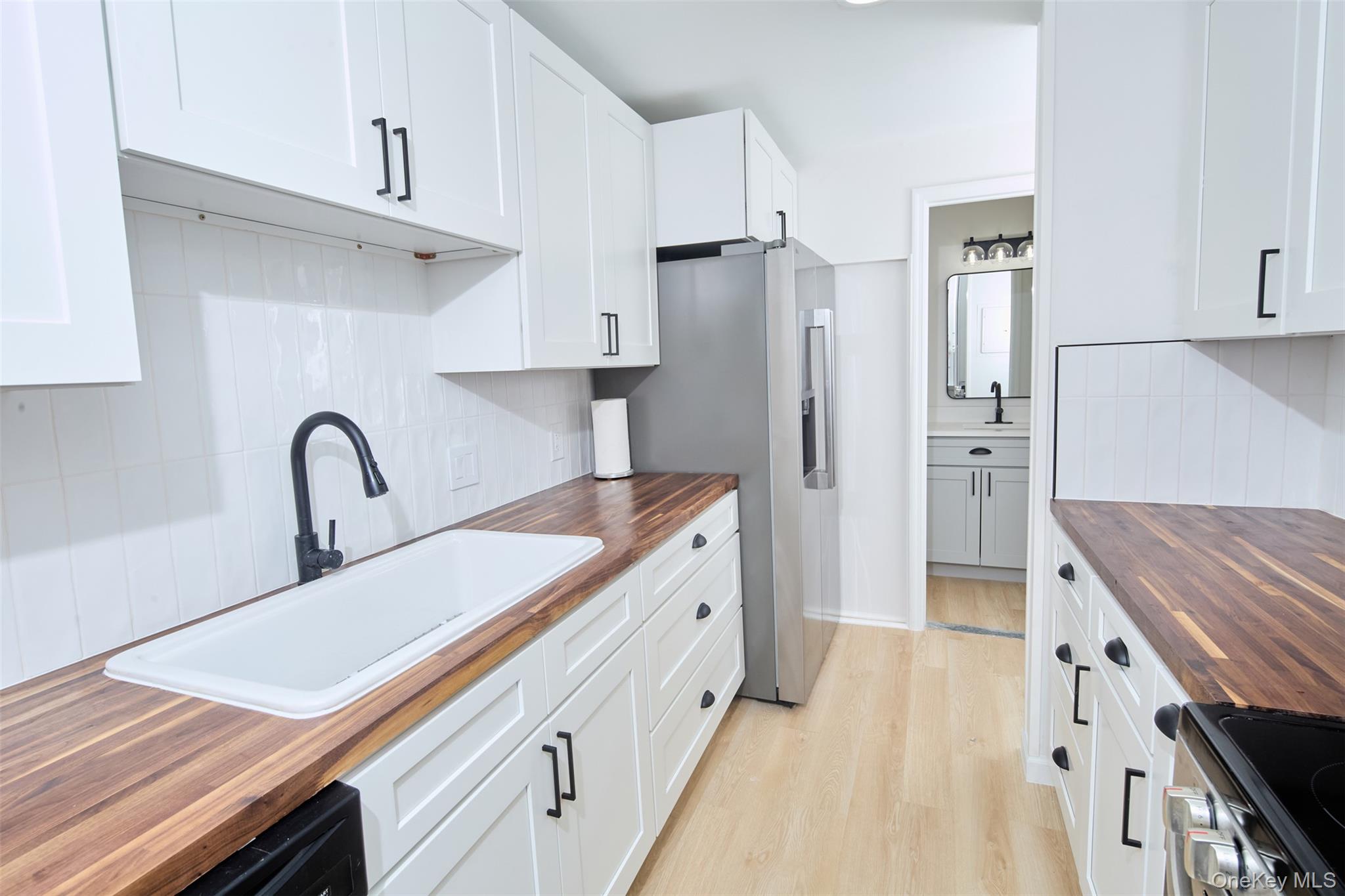 a kitchen with stainless steel appliances granite countertop a refrigerator and a stove top oven