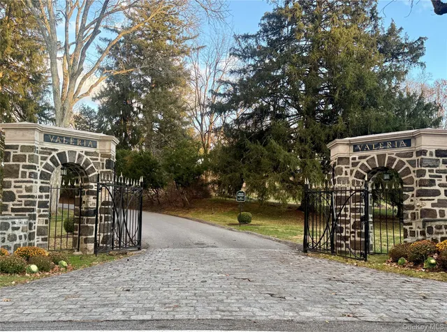 a front view of residential houses with yard and trees