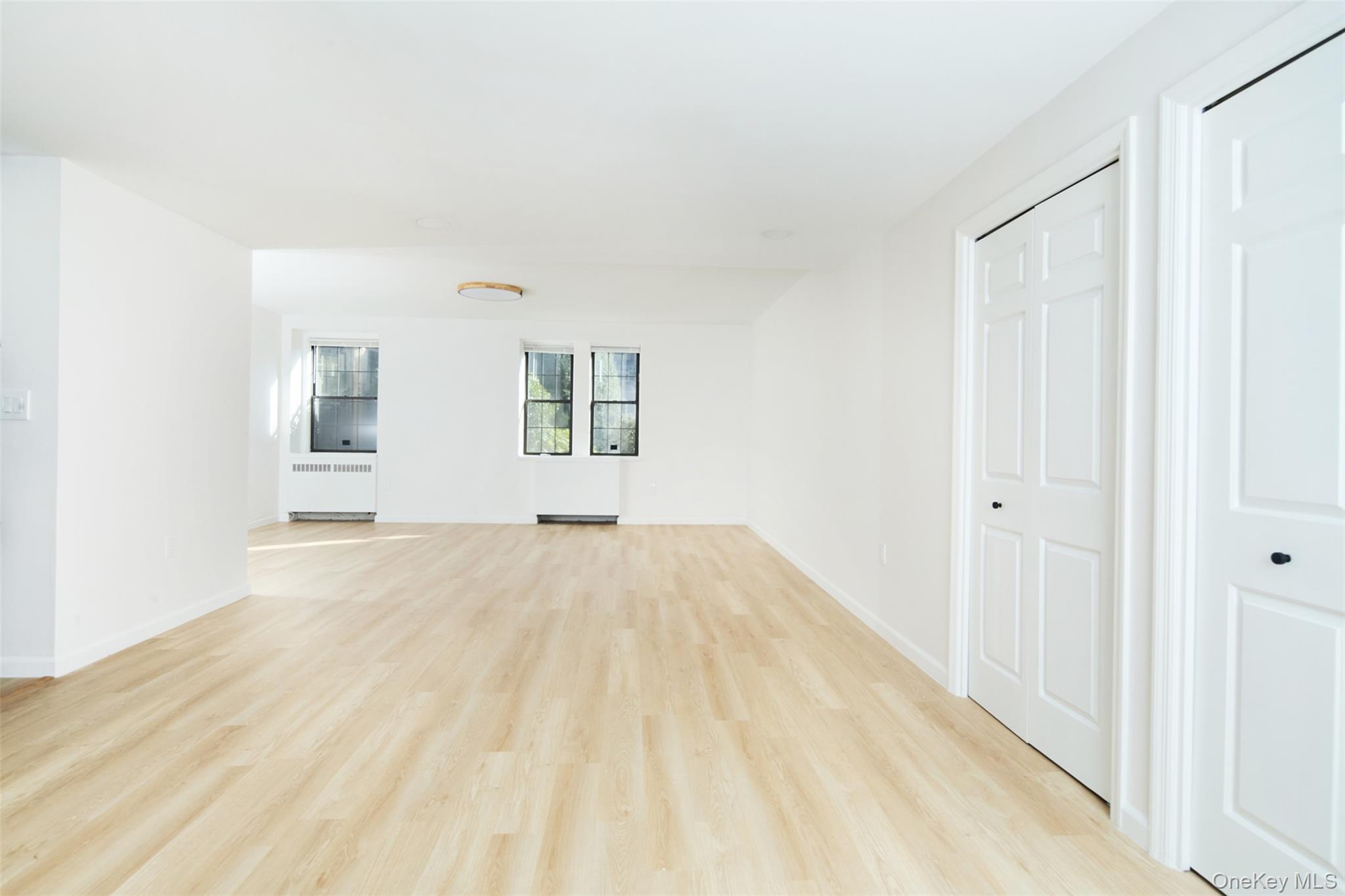 341 Furnace Dock Road, Unit 35 Cortlandt Manor, NY 10567 - Photo 4 of 25 a view of empty room with wooden floor and fan