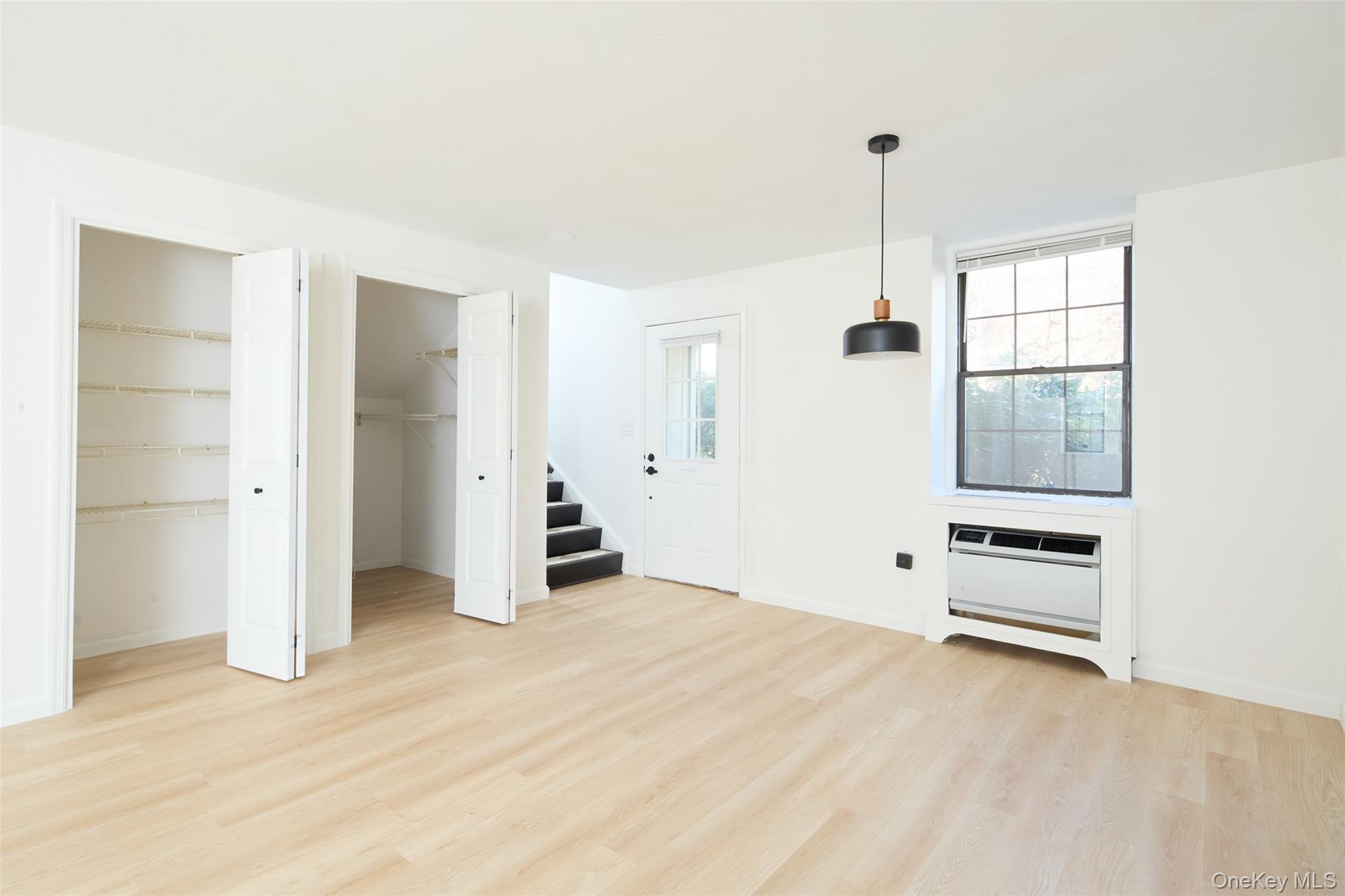 341 Furnace Dock Road, Unit 35 Cortlandt Manor, NY 10567 - Photo 7 of 25 a view of an empty room with closet and windows
