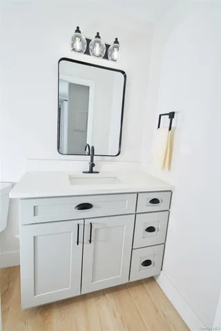 a bathroom with a sink vanity and mirror