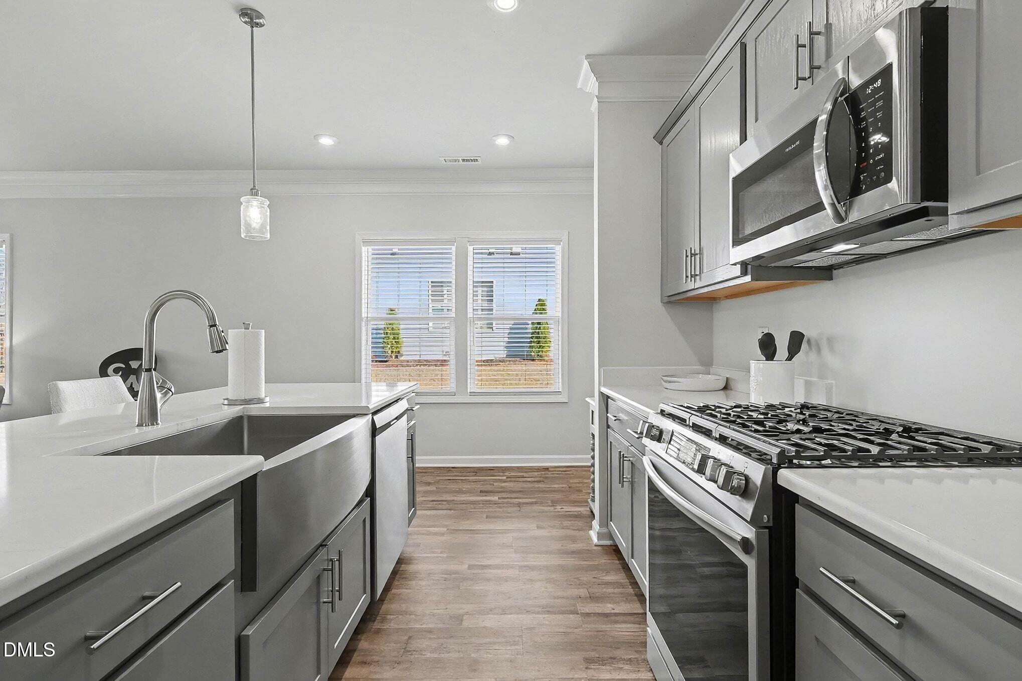 266 Shingle Oak Road Wake Forest, NC 27587 - Photo 9 of 36 a kitchen with stainless steel appliances a sink a stove and cabinets