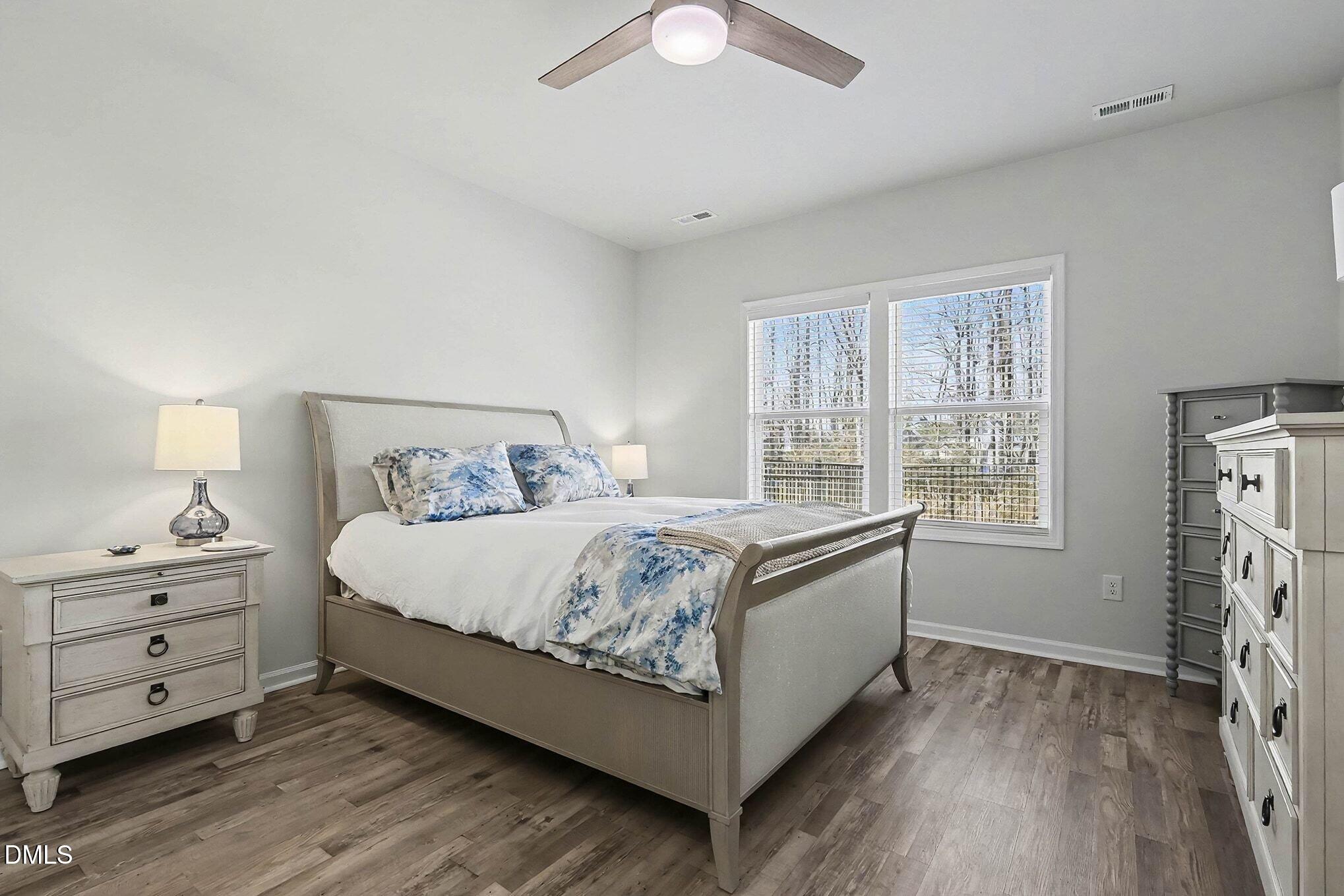266 Shingle Oak Road Wake Forest, NC 27587 - Photo 13 of 36 a bedroom with a bed and a chandelier