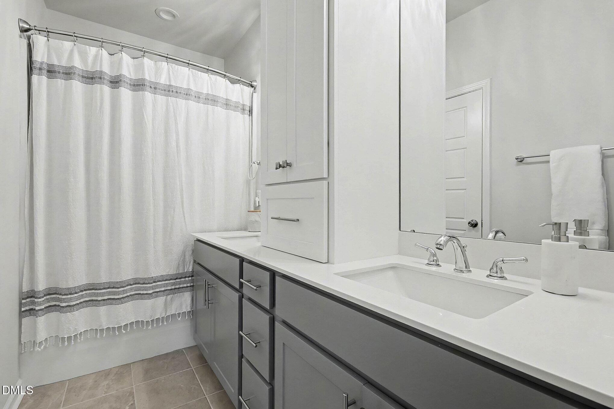 266 Shingle Oak Road Wake Forest, NC 27587 - Photo 14 of 36 a bathroom with a sink and a mirror