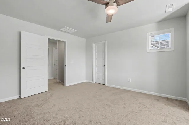 an empty room with a fireplace and a window