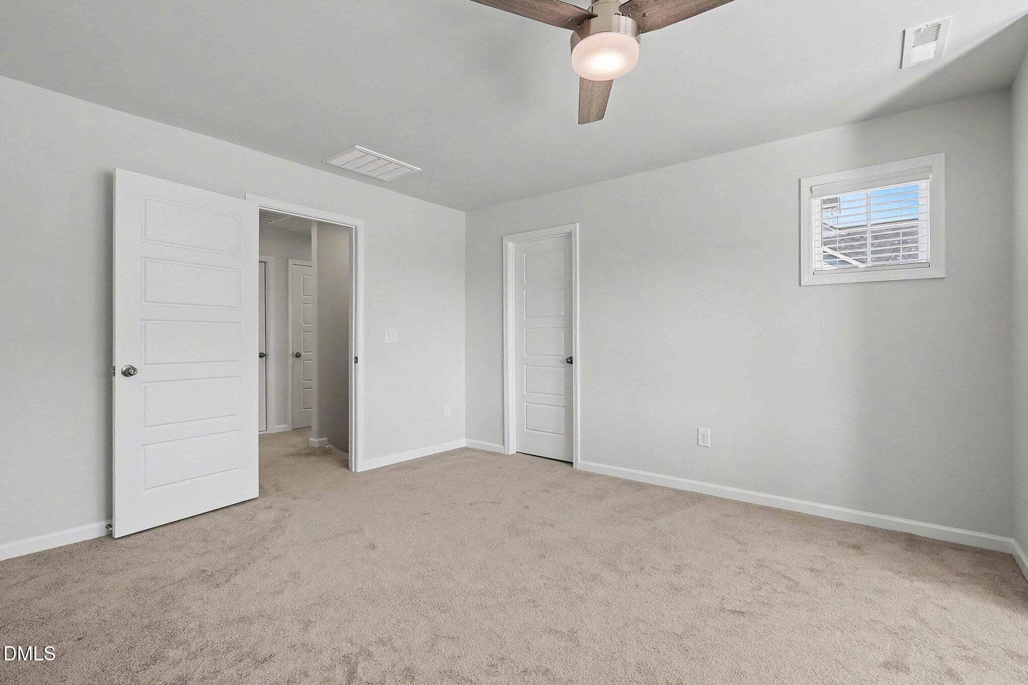 266 Shingle Oak Road Wake Forest, NC 27587 - Photo 20 of 36 a view of an empty room with a chandelier fan