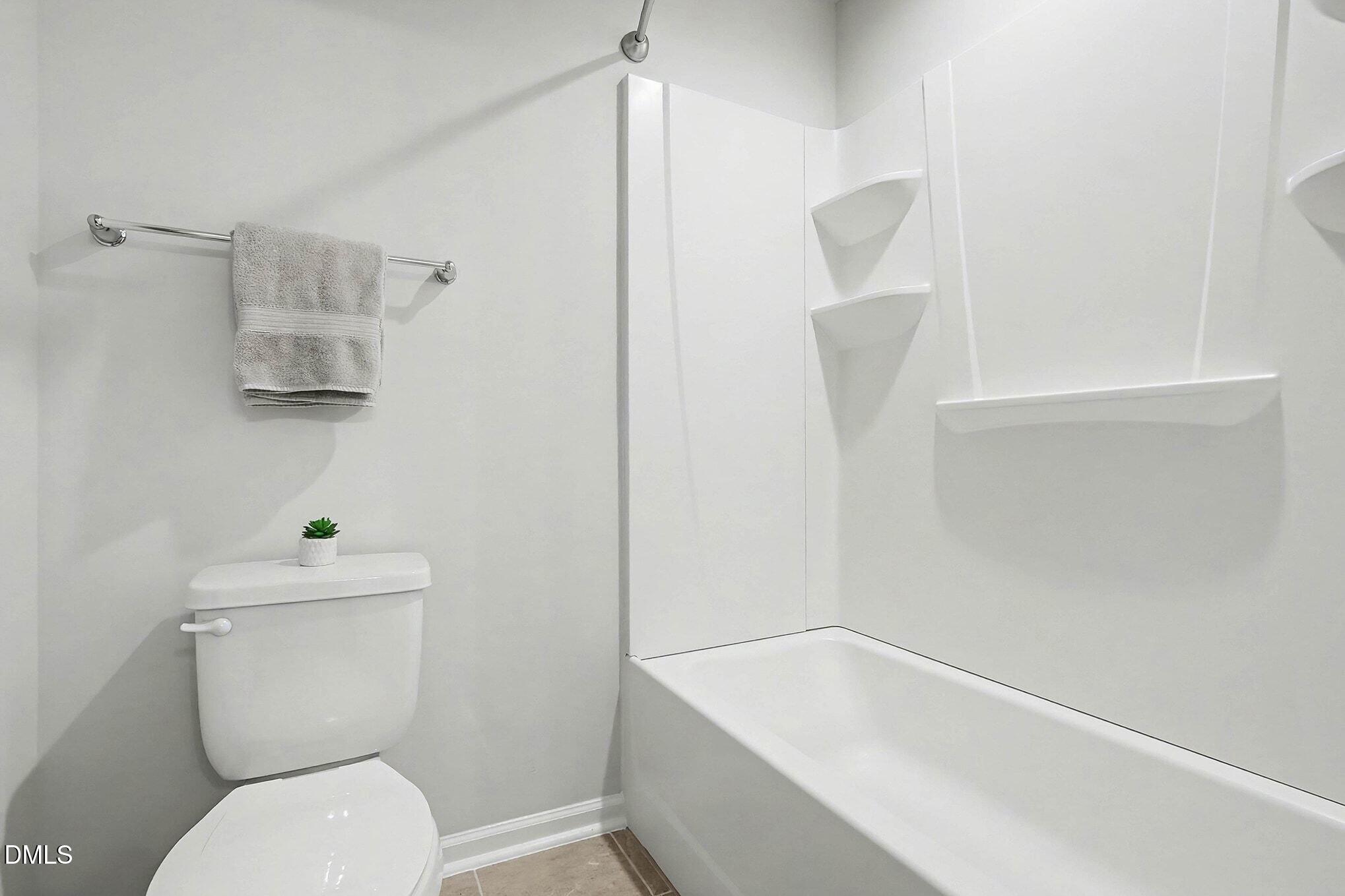 266 Shingle Oak Road Wake Forest, NC 27587 - Photo 21 of 36 a white toilet sitting next to a bathroom sink