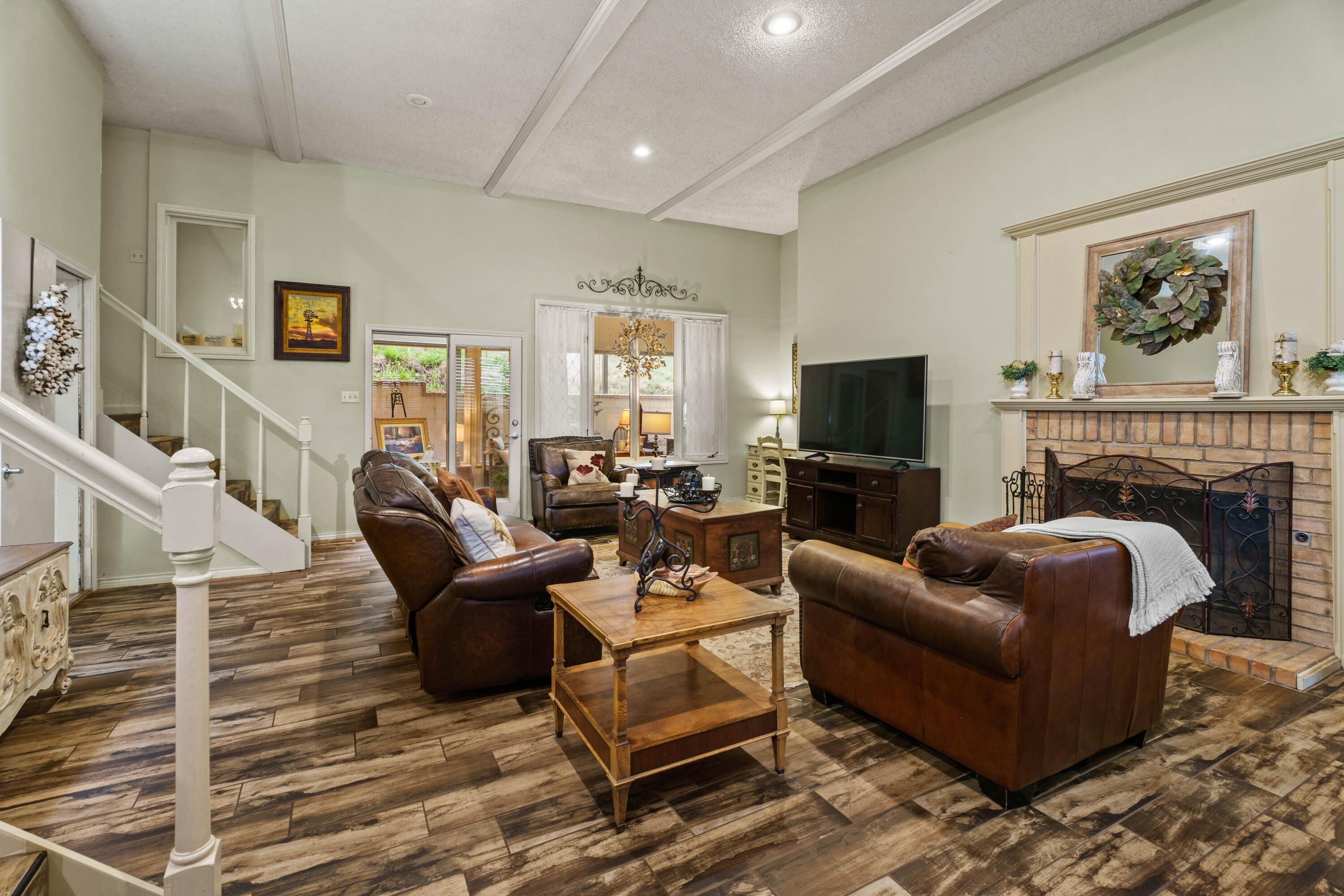 47 South Lake Shore Drive Ransom Canyon, TX 79366 - Photo 11 of 33 a living room with furniture a flat screen tv and a fireplace