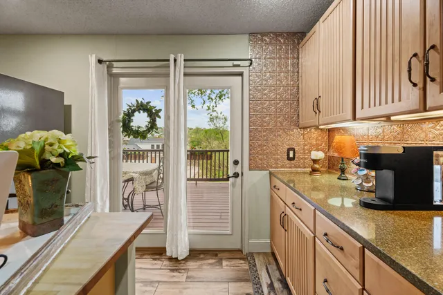 a kitchen with stainless steel appliances granite countertop sink stove and refrigerator