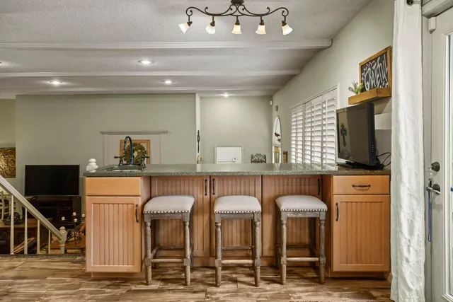 a kitchen with stainless steel appliances granite countertop a sink and a refrigerator