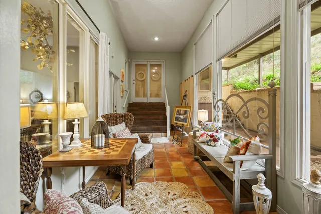 a living room with furniture and a floor to ceiling window
