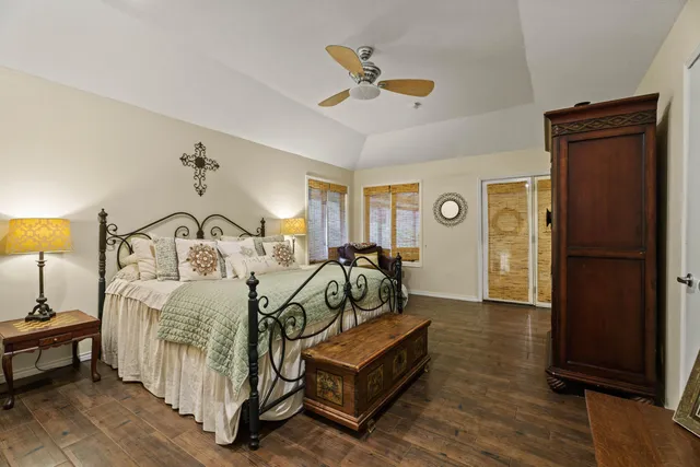a spacious bedroom with two beds and a chandelier