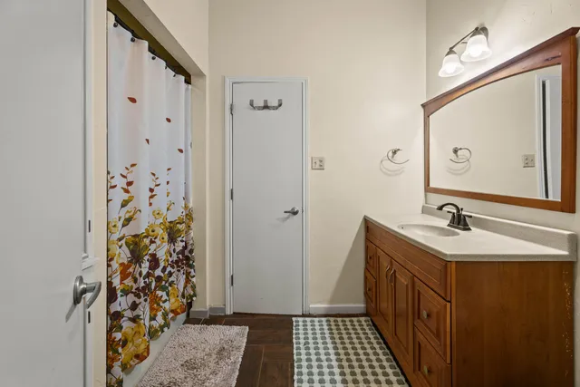 a living room with furniture a desk and chair with wooden floor