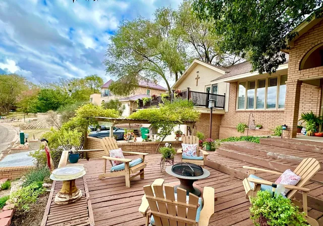 a view of a patio with couches table and chairs and potted plants