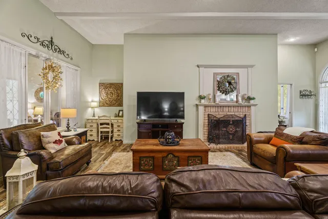 a living room with furniture a flat screen tv and a fireplace