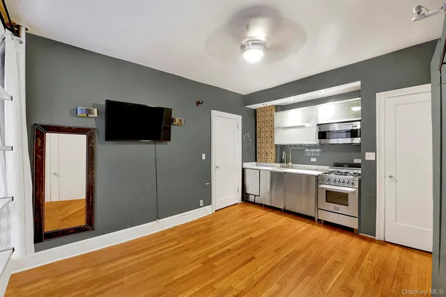 a kitchen with stainless steel appliances kitchen island granite countertop a refrigerator and a stove top oven