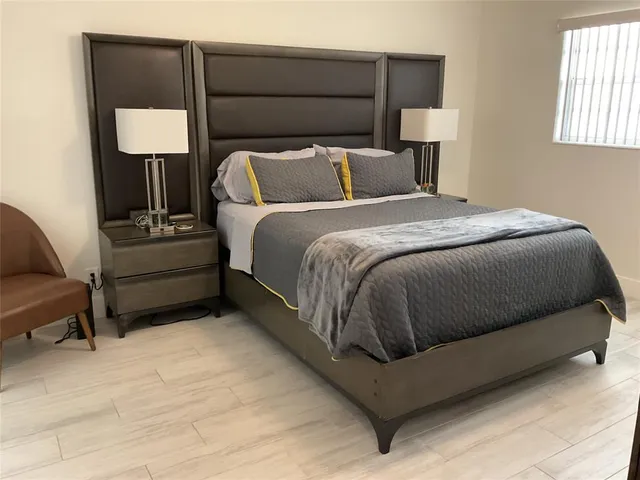 a bedroom with a bed and a lamp