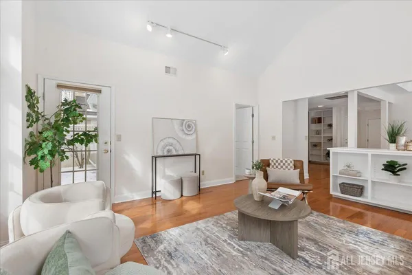 a living room with furniture and wooden floor