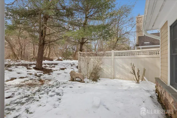 a view of a house with a yard covered in snow