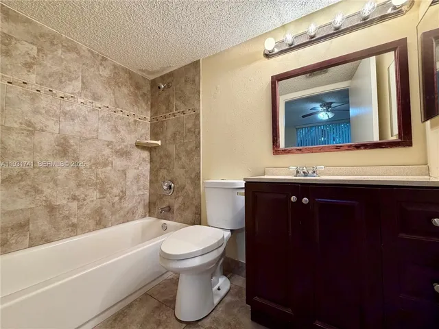 a bathroom with a toilet a sink and bathtub
