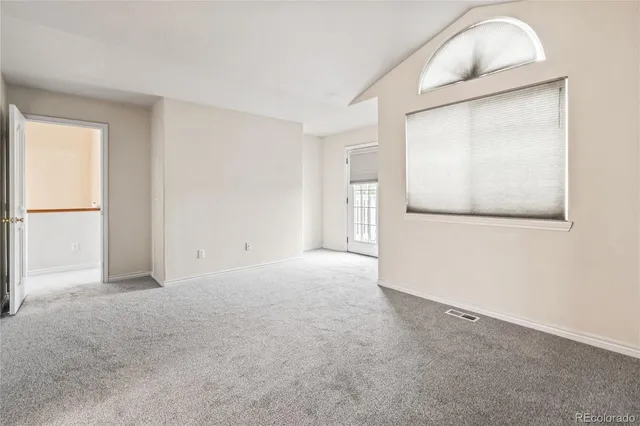 an empty room with closet and mirror