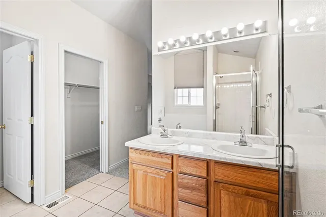 a bathroom with a double vanity sink and mirror