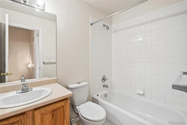 a bathroom with a sink toilet vanity and shower