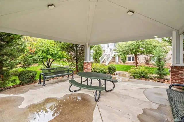 a view of a patio with a table chairs and a backyard