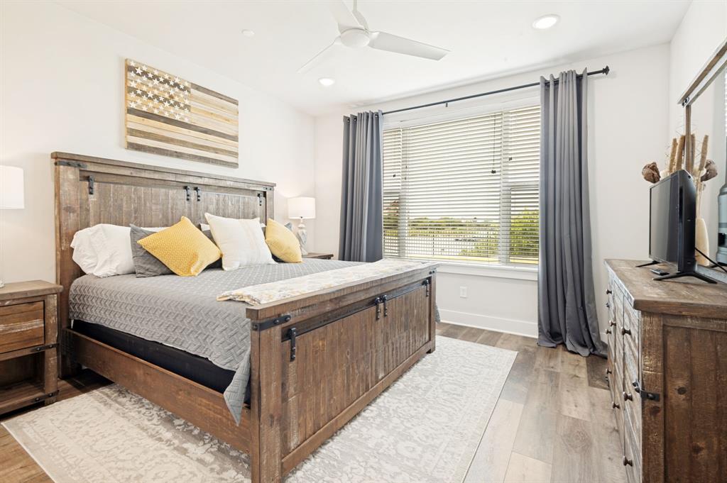 3412 Scenic Point Road, Unit 102 Graford, TX 76449 - Photo 17 of 31 a bedroom with a bed and a flat screen tv