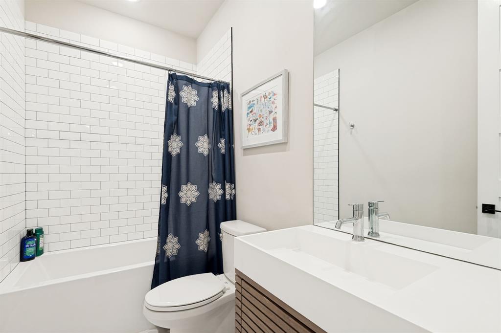 3412 Scenic Point Road, Unit 102 Graford, TX 76449 - Photo 20 of 31 a bathroom with a sink a toilet and shower