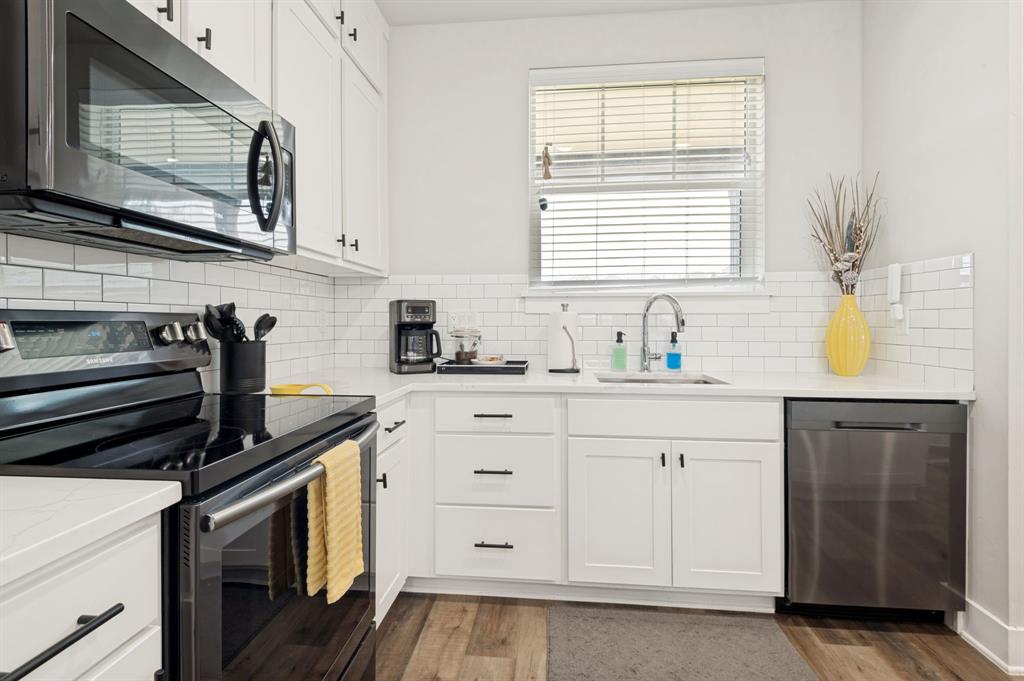 3412 Scenic Point Road, Unit 102 Graford, TX 76449 - Photo 7 of 31 a kitchen with cabinets appliances and a window