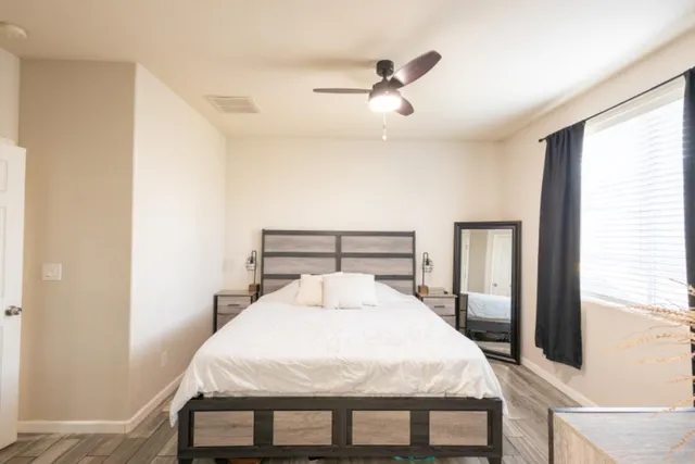 a bed sitting in a bedroom next to a window