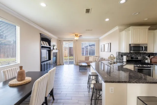 a living room with fireplace furniture and a wooden floor