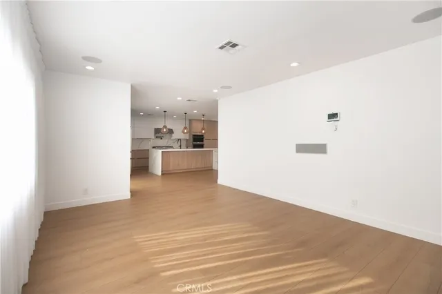 a view of a kitchen with a refrigerator and a sink