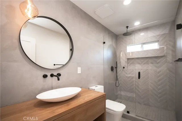 a bathroom with a toilet a sink and a mirror