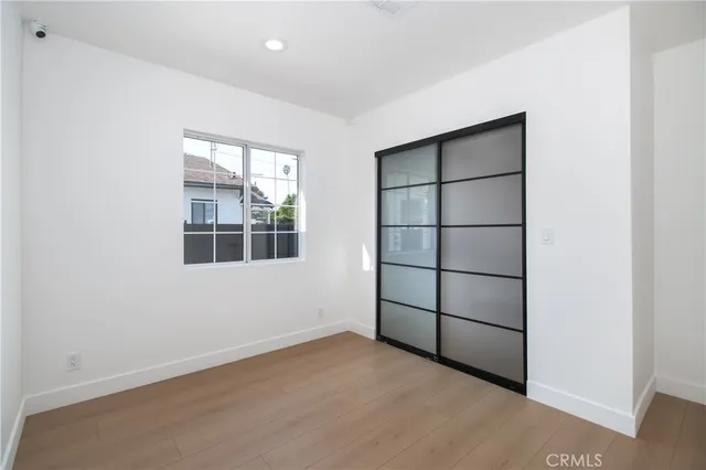 an empty room with windows and closet