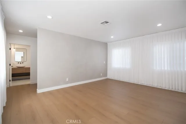 an empty room with cabinet and a bathroom