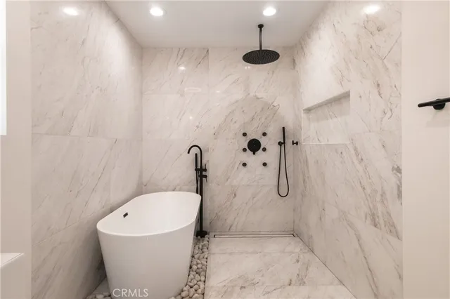 a bathroom with a bathtub and shower