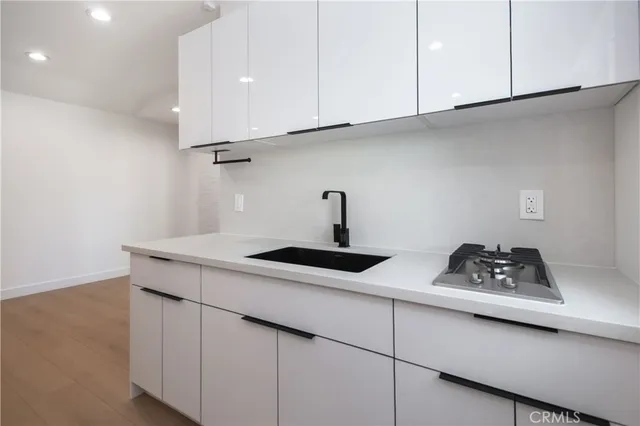 a kitchen with cabinets and white appliances