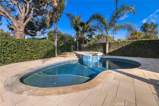 a view of a swimming pool with sitting area
