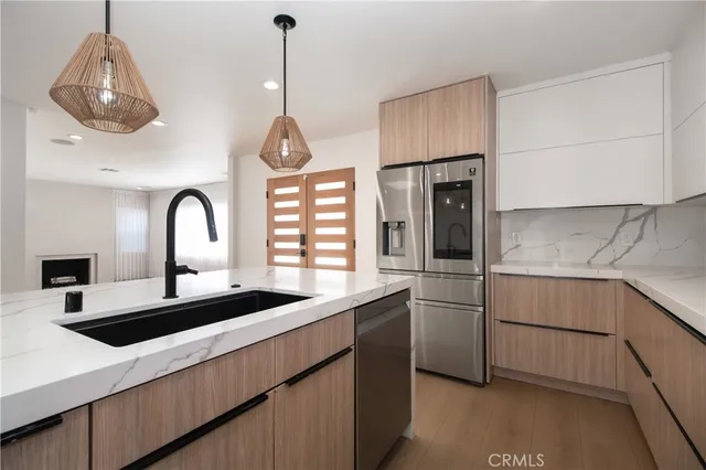 a kitchen with stainless steel appliances a sink a counter space and cabinets