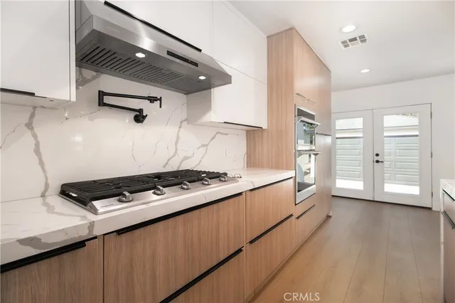 a kitchen with stainless steel appliances granite countertop a stove and a refrigerator