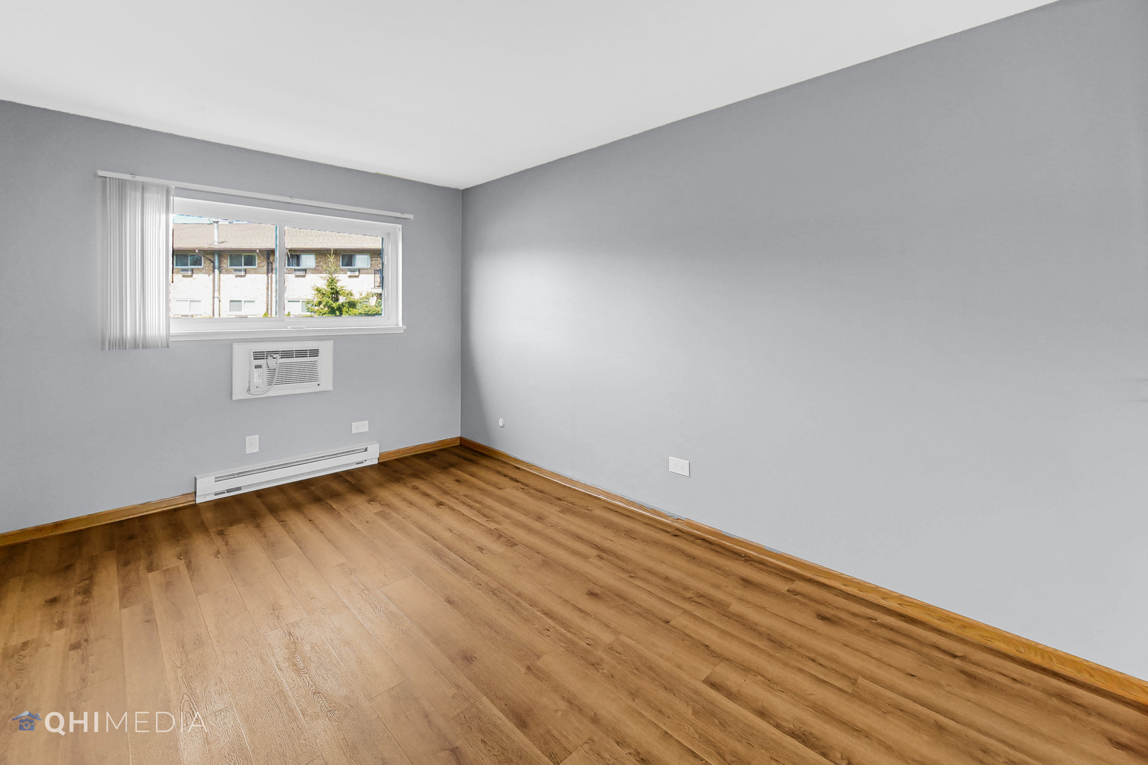 838 East Old Willow Road, Unit 103 Prospect Heights, IL 60070 - Photo 11 of 20 a view of an empty room with wooden floor and a window