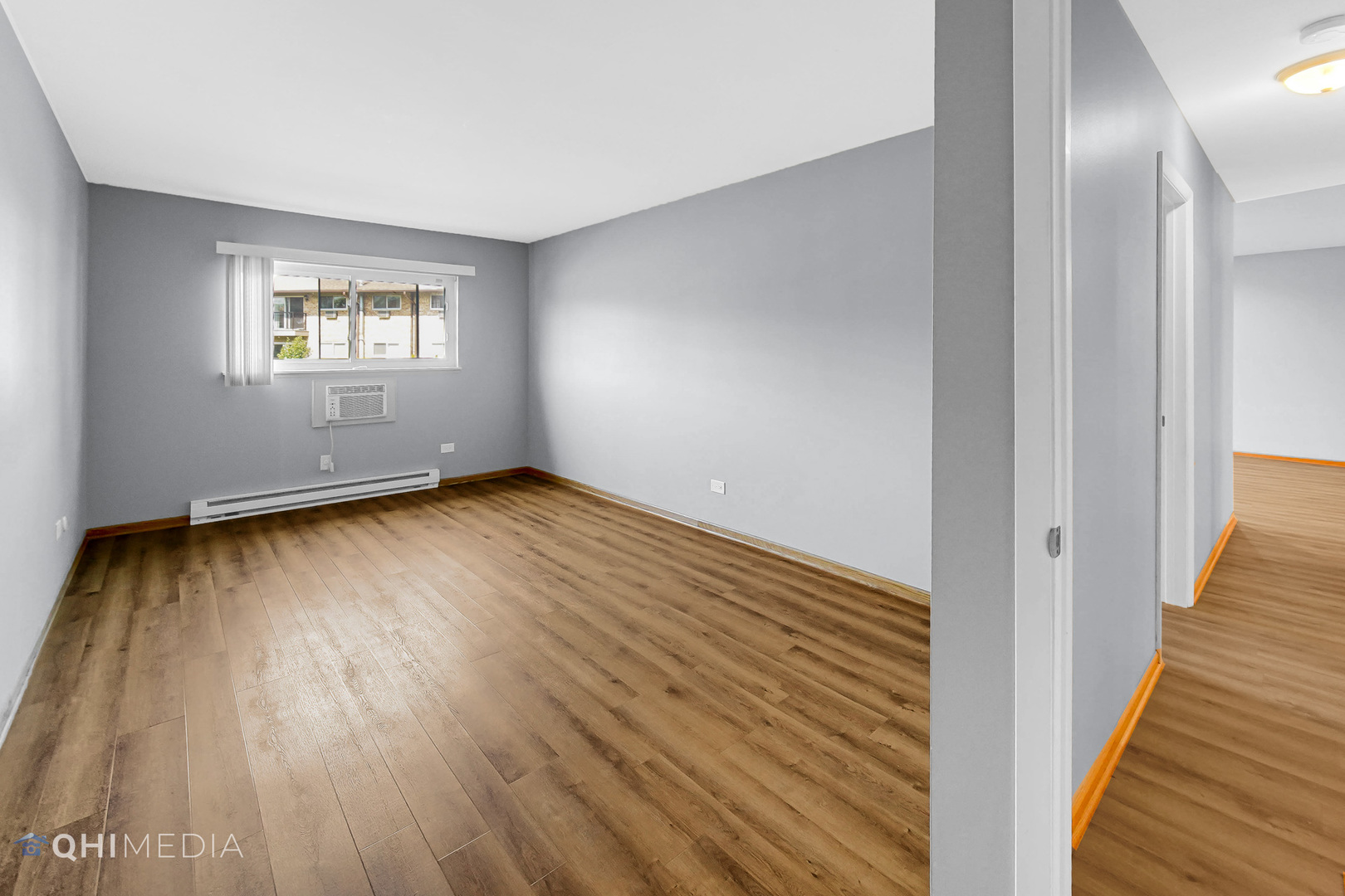 838 East Old Willow Road, Unit 103 Prospect Heights, IL 60070 - Photo 14 of 20 a view of an empty room with wooden floor and a window