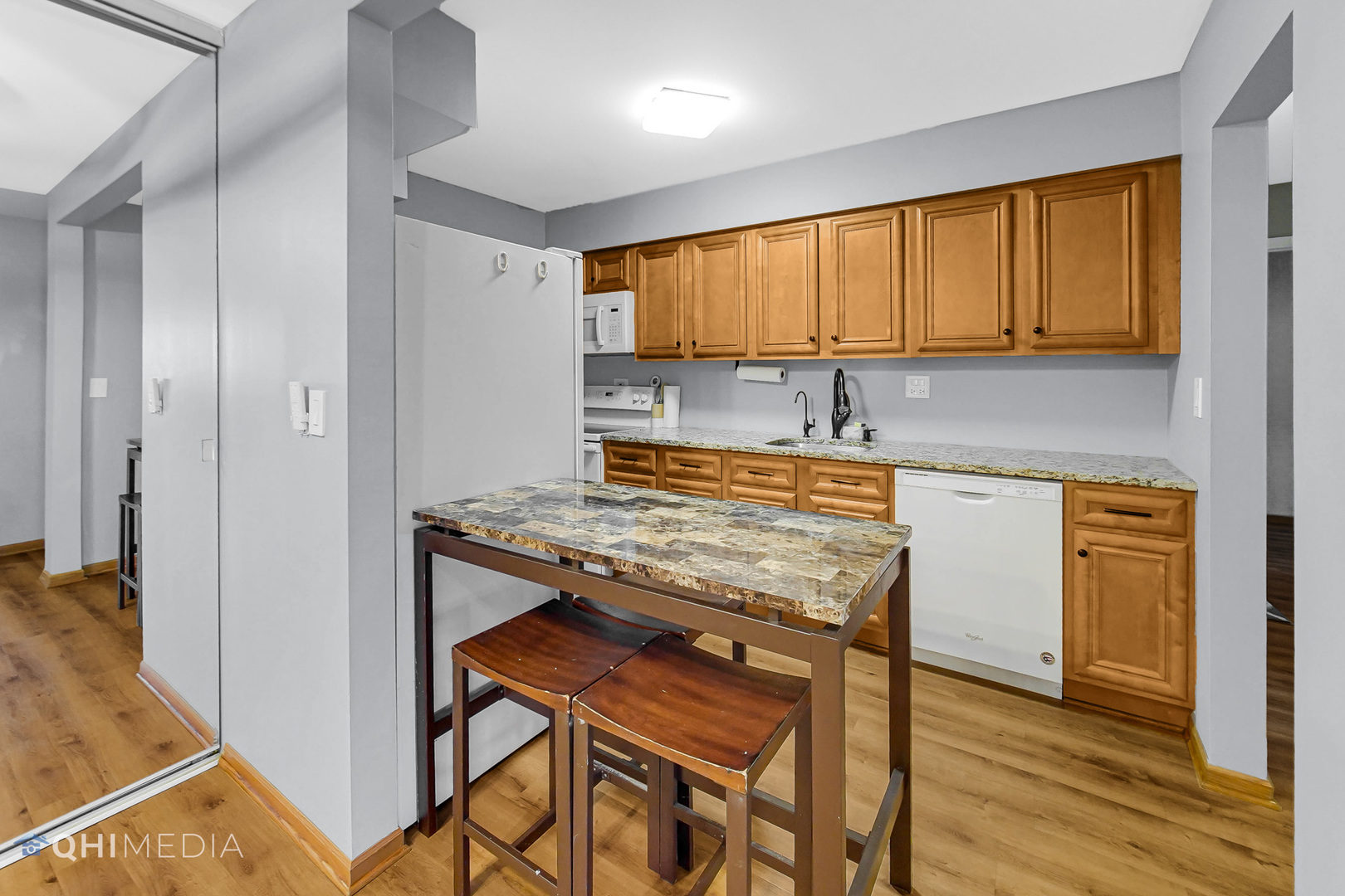 838 East Old Willow Road, Unit 103 Prospect Heights, IL 60070 - Photo 8 of 20 a kitchen with a stove a sink and a refrigerator