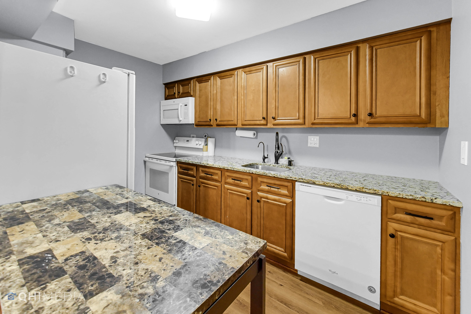 838 East Old Willow Road, Unit 103 Prospect Heights, IL 60070 - Photo 9 of 20 a kitchen with stainless steel appliances granite countertop a sink stove and refrigerator