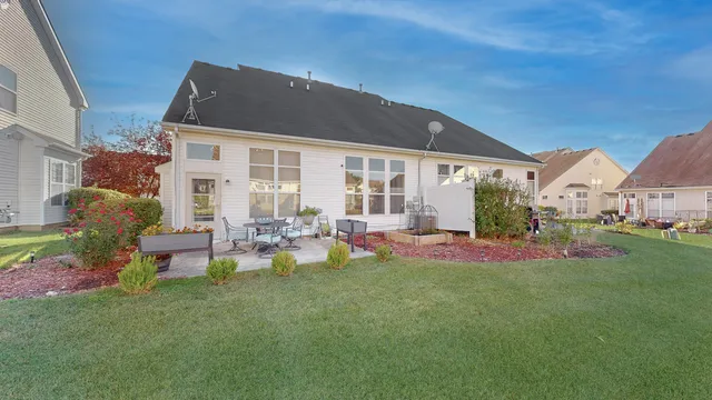 a view of a house with backyard porch and sitting area
