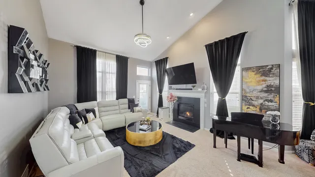 a living room with furniture a fireplace and a flat screen tv