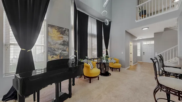 a living room with furniture and floor to ceiling window